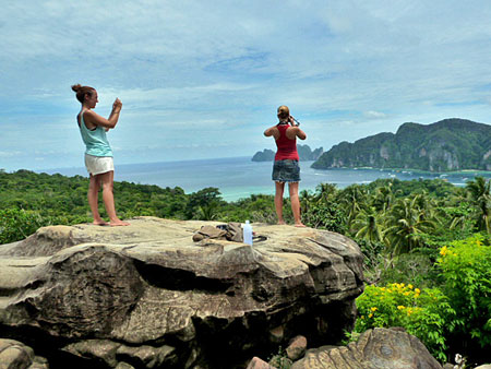 Two beautiful French girls look out over Ao Ton Sai bay from viewpoint two on Ko Phi Phi Don, Thailand.