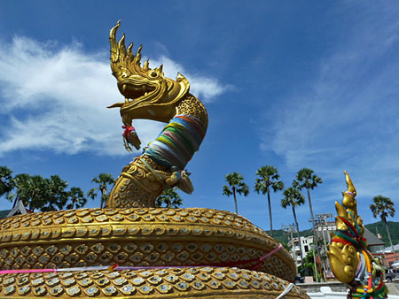 A golden dragon sunbathes on Karon beach in Phuket, Thailand.