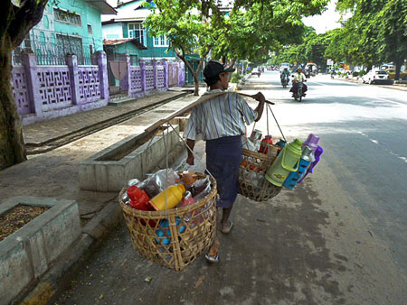 The Bottle Man knows his way around town in Mandalay, Myanmar.
