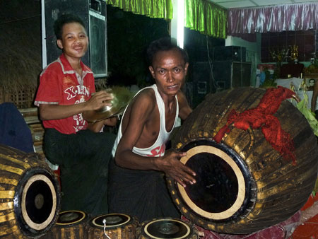 A cymbal player and a drummer beat time and increase the heat at the nat pwe in Taungbyone, Myanmar.
