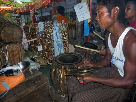 Close-up on another cymbal player and a drummer at the nat pwe in Taungbyone, Myanmar.