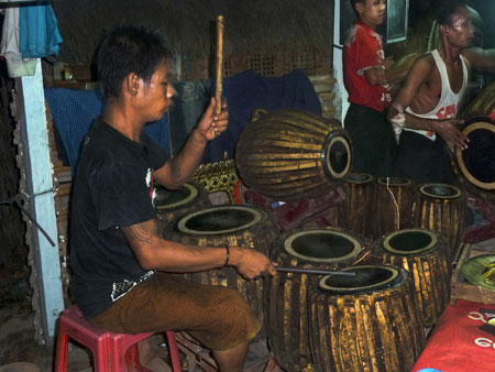 A chauk lone bat drummer wails the night away at the nat pwe in Taungbyone, Myanmar.