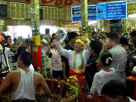 A nat kadaw performs his services in the main temple at the nat pwe in Taungbyone, Myanmar.