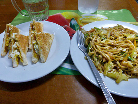 An egg sandwich and noodles at the Motherland Inn II in Yangon, Myanmar.
