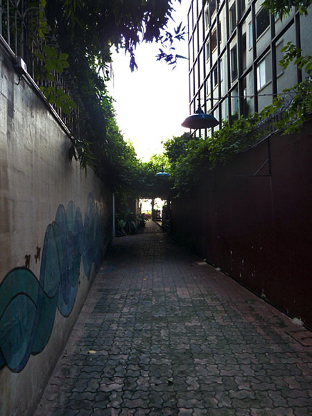An alley leading to Phra Ahtit pier on the Chao Phraya river in Bangkok, Thailand.
