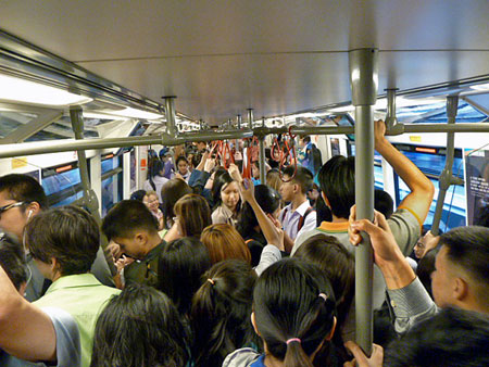 An overloaded Skytrain does its best can of Vienna sausages imitation in Bangkok, Thailand.