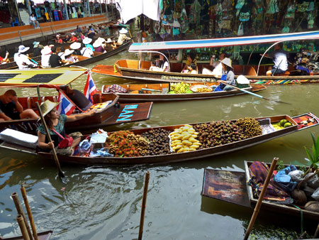 Traffic increases at the floating market in Damnoen Saduak, Thailand.