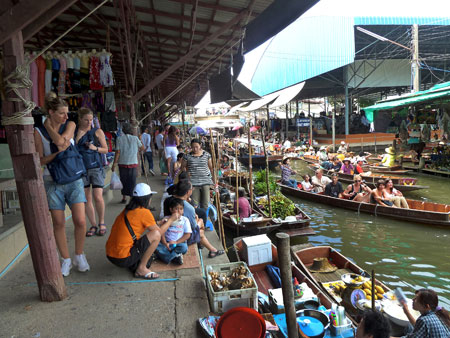 The full-blown daily tourist frenzy gathers steam at the floating market in Damnoen Saduak, Thailand.