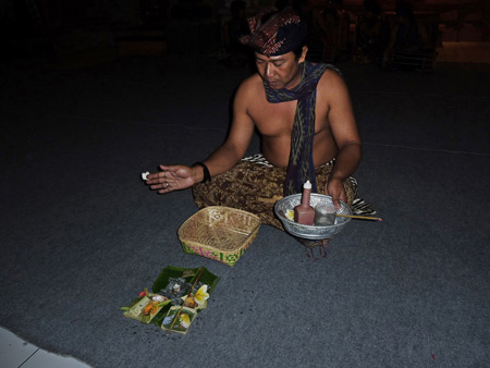 A member of Tetamian blesses the performance space at Pura Agung Peliatan in Peliatan, Bali, Indonesia.