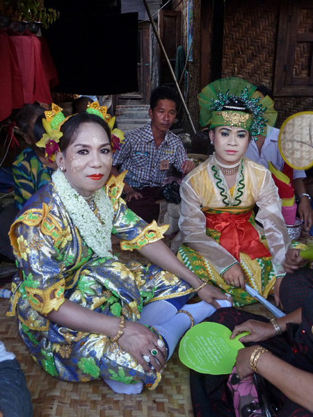 A couple of nat kadaws relax at the Nat Pwe in Taungbyone, Myanmar.