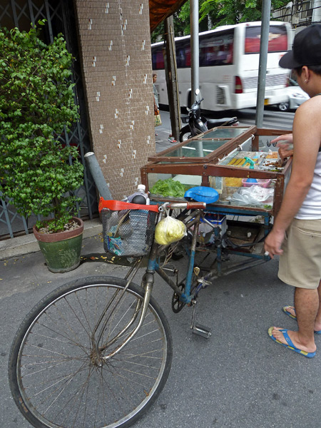 A low-slung bicycle food cart in Bangkok, Thailand.