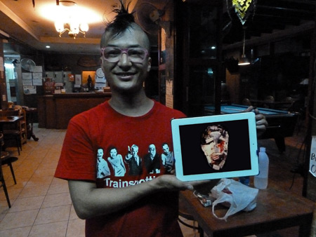 Takuya Ando shows off a This Heat album on his iPad at the Nat 2 Guesthouse in Banglamphu, Bangkok, Thailand.