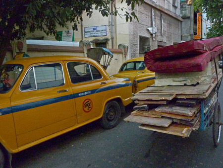 An accidental photo of some taxi cabs and a rickshaw in Kolkata, India.