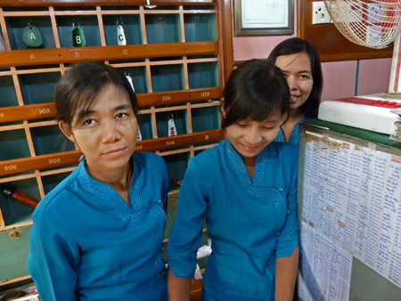 Three of the big staff who run the Royal Guest House in Mandalay, Myanmar.