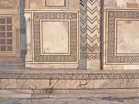 A close-up of the intricately patterned stonework on the Taj Mahal mausoleum in Agra, India.