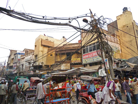 Gnarled power lines rule this scene on Chowri Bazaar in Old Delhi, India.