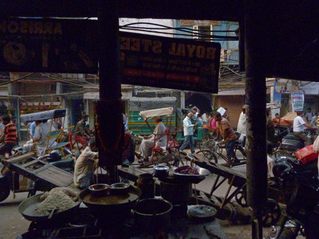 A view from the inside looking out at all of the chaos on Chowri Bazaar in Old Delhi, India.