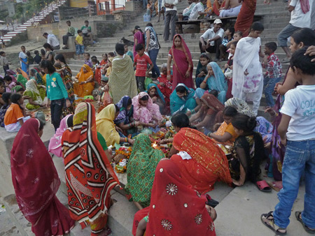 A group of women performs a Hindu ceremony at Kedar Ghat in Varanasi, India.