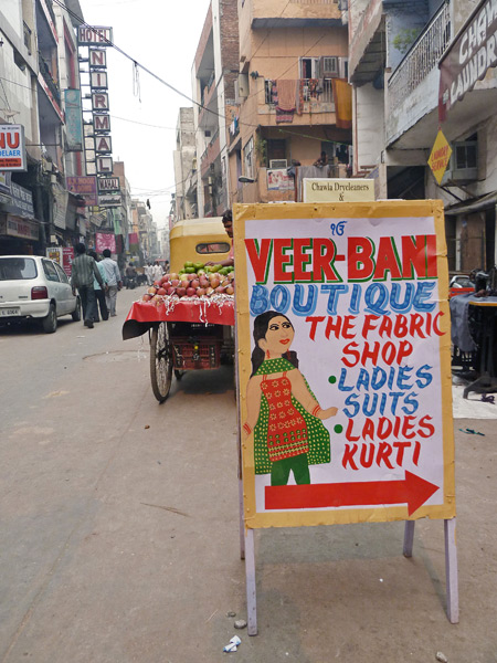 A colorful sign beckons passersby into a shop in the back lanes of Paharganj, Delhi, India.