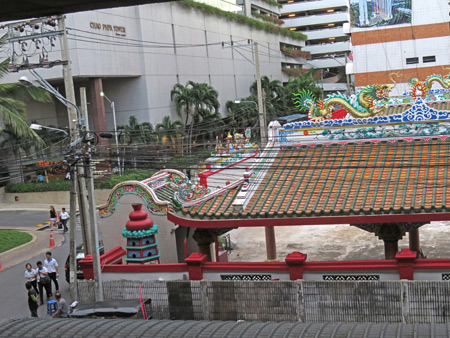 A Chinese Buddhist temple as seen from the Saphan Taksin SkyTrain stop in Silom, Bangkok, Thailand.