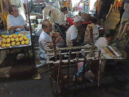 Traditional Thai musicians jam at a night market on Thanon Ratchadamnern in Chiang Mai, Thailand.