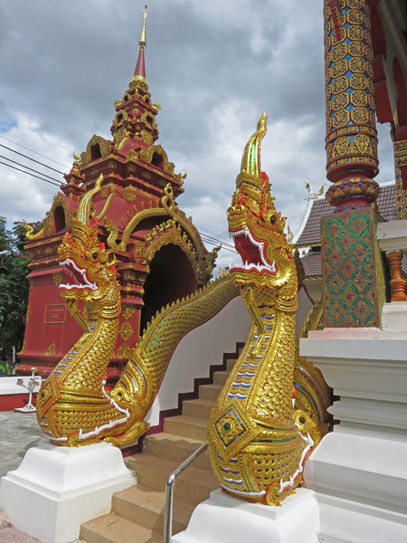 Golden dragons guard Wat That Kham in Chiang Mai, Thailand.
