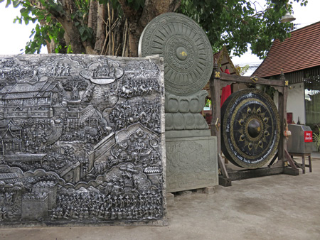 A chiseled silver panel and a gong at Wat Sri Suphan in Chiang Mai, Thailand.