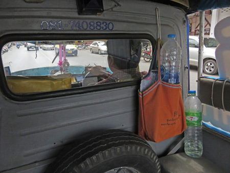 Taking a tuk-tuk to the bus station in Phitsanulok, Thailand.