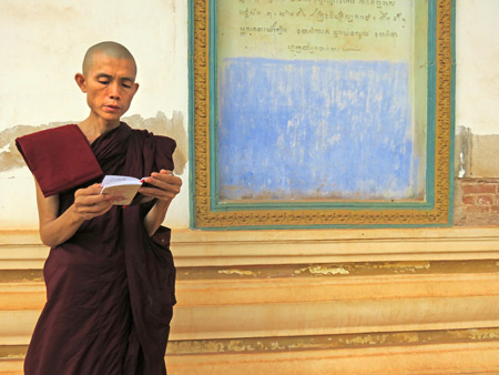 A Buddhist monk brushes up on a lesson before giving a sermon at Wat Preah An Kau Saa in Siem Reap, Cambodia.