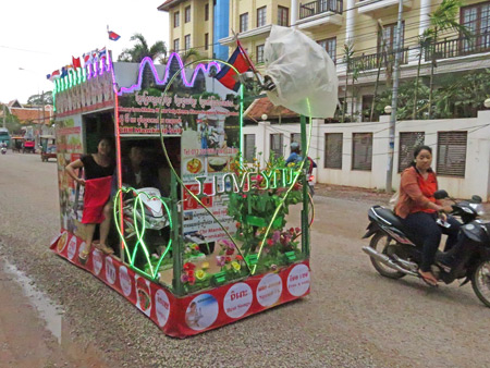 A promotional float cruises down the street in Siem Reap, Cambodia.