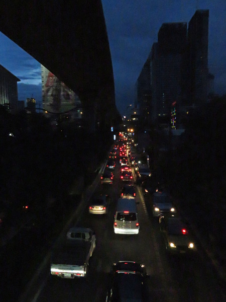 Evening traffic beneath the SkyTrain on Thanon Sukhumvit in Bangkok, Thailand.
