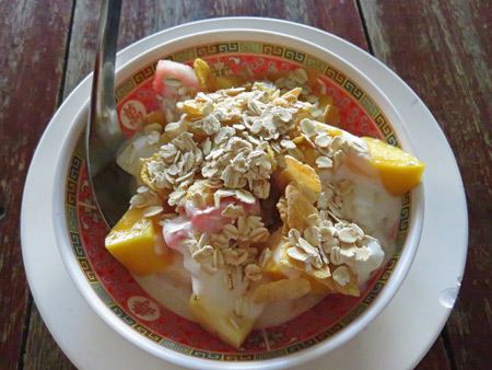 Fruit, yogurt and muesli for breakfast at Number One Vegetarian Restaurant in Banglamphu, Bangkok, Thailand.