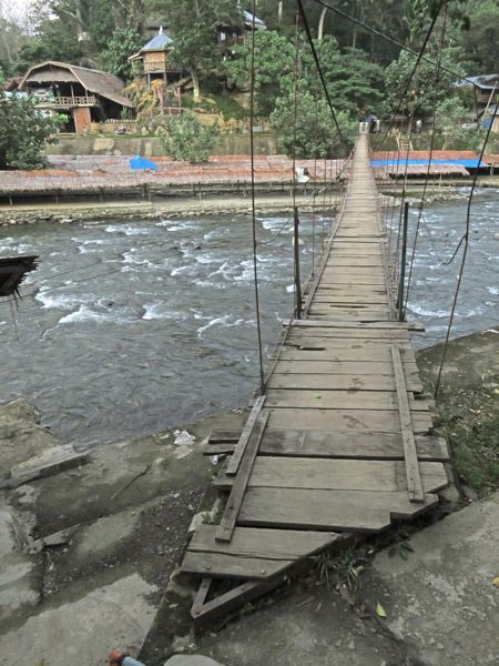 Another rickety wooden bridge crossing the Bohorok river in Bukit Lawang, Sumatra, Indonesia.