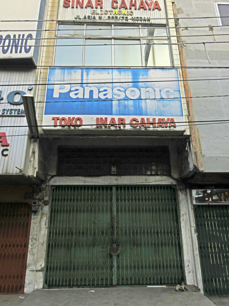 Faded shop signs in Medan, Sumatra, Indonesia.