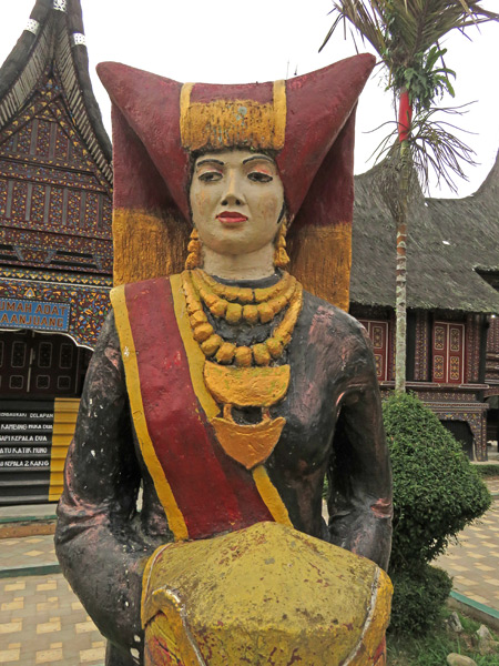 A statue of a traditional Minangkabau woman at the zoo in Bukittinggi, Sumatra, Indonesia.