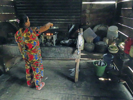 A woman brews up a meal in her kitchen in Rao Rao near Bukittinggi, Sumatra, Indonesia.