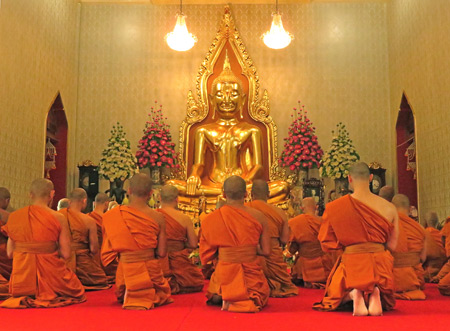 An afternoon Buddhist prayer service at Wat Traimit in Chinatown, Bangkok, Thailand.