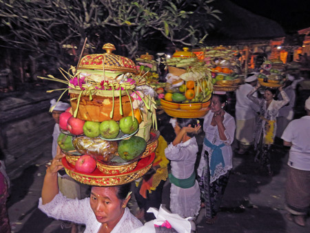 Women carry offerings on their heads during a Hindu temple ceremony at Pura Dalem Desa Pakraman Taman Kaja in Ubud, Bali, Indonesia.