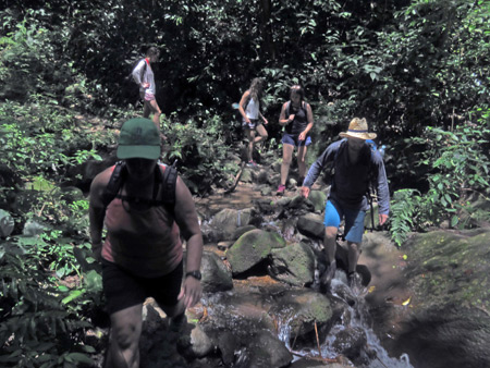 Traversing a rocky creek bad during the hike back down from San Ramon Waterfalls on Volcano Maderas, Isla de Ometepe, Nicaragua.