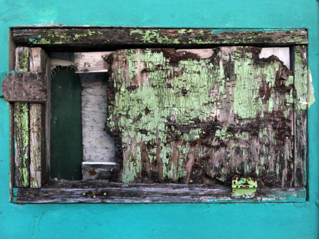 An extremely distressed window in Caye Caulker, Belize.