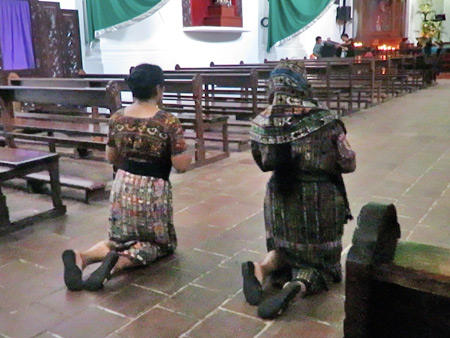 Devotees walk backward on their knees while praying in the Iglesia San Francisco in downtown Panajachel, Lago de Atitlan, Guatemala.