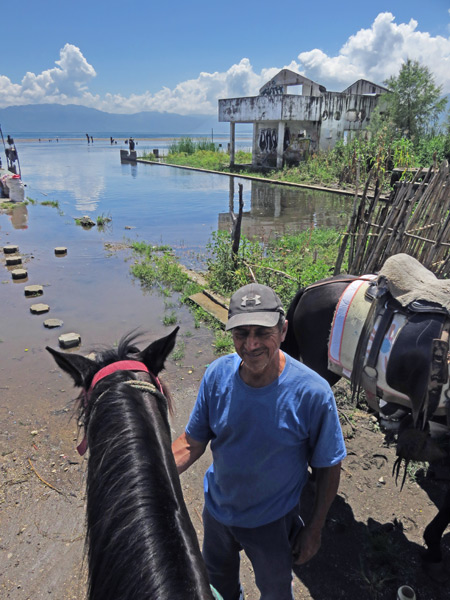 Moises takes a break at the lake shore near San Pedro, Lago de Atitlan, Guatemala.