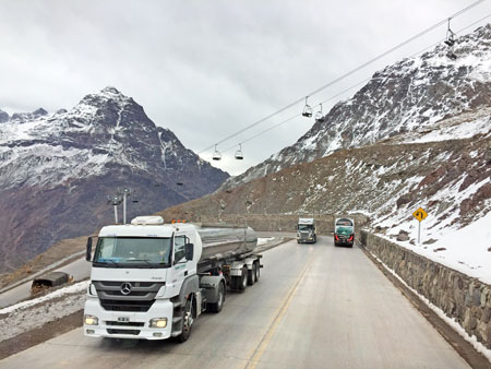 Long haul trucks negotiate some switchbacks in the Andes mountains, Chile.