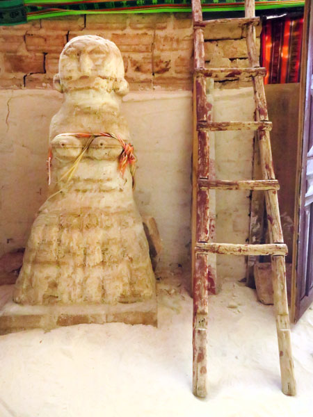 A salt statue and a rickety ladder in an old salt hostel on the Salar de Uyuni, Bolivia.