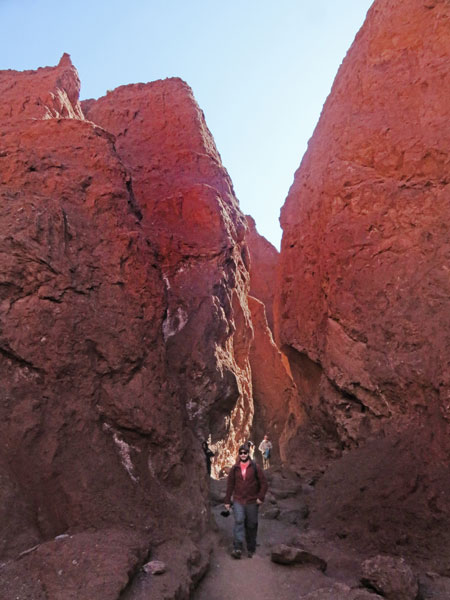 Walking through a crevice in the Valle de Arcoiris, near San Pedro de Atacama, Chile.