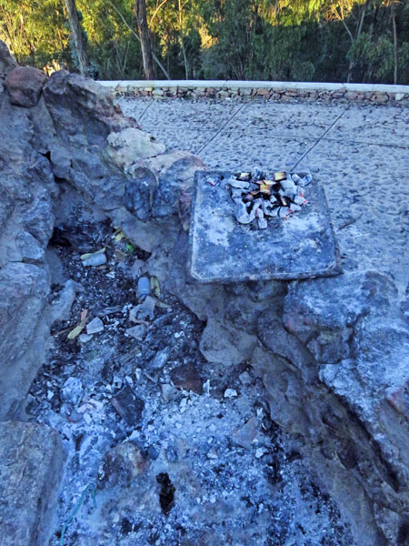 Burnt offerings on the base of the Cristo del Sagrado Corazón on the summit of Cerro Churuquella in Sucre, Bolivia.