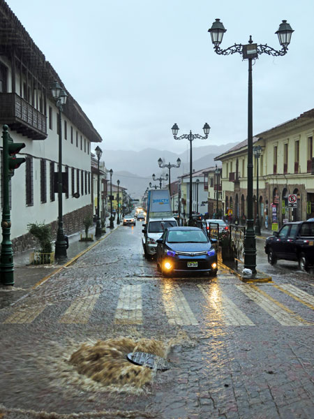 A hovering sewer lid courtesy of flooded pipes during a torrential rainstorm in Cuzco, Peru.