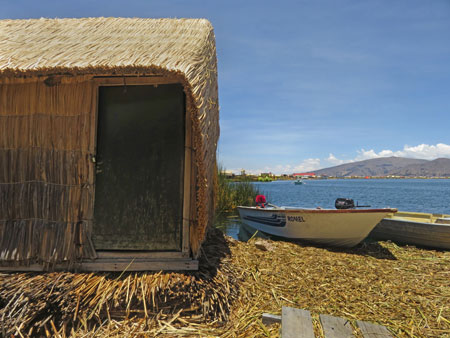 A totora reed hut and a boat on the Uros Islands near Puno, Peru.