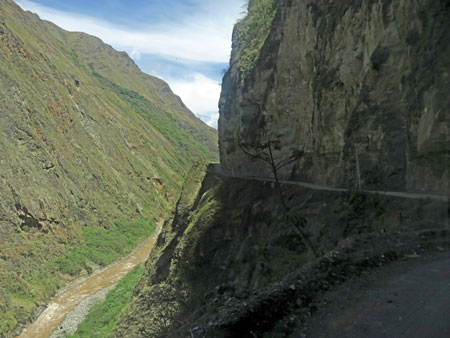 A gravel road perched precariously on a cliff near Hidroelectrica, Peru.